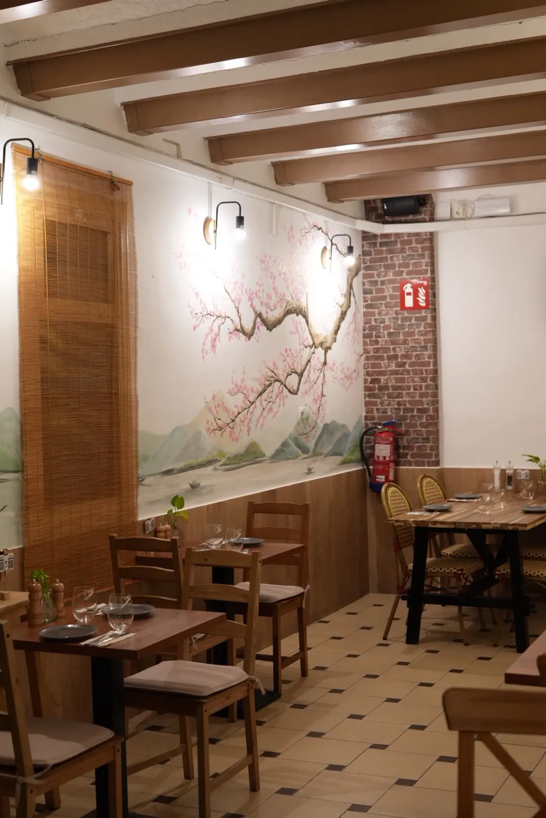 The dining room with the cherry blossom mural and wooden beams