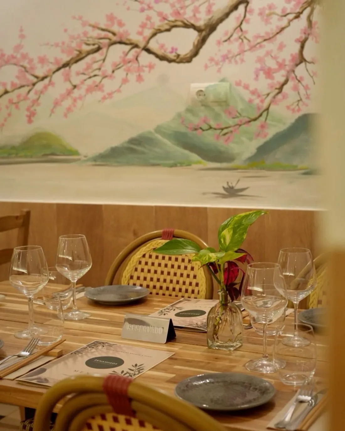 Wine glasses on a table under the painted cherry blossom
